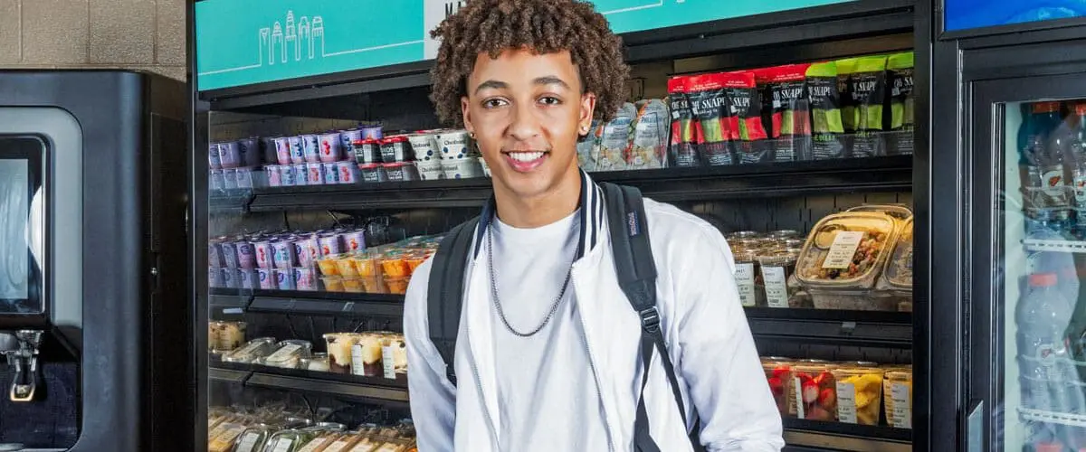 Smiling student in front of c-store display