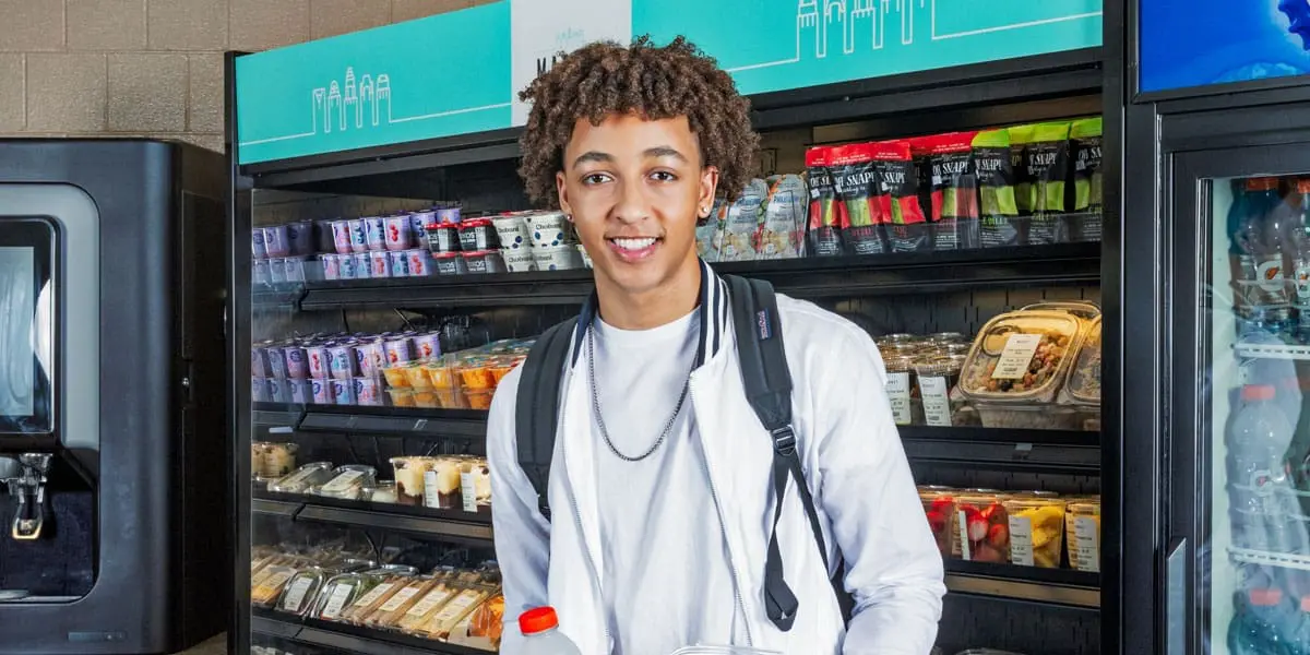 Smiling student in front of c-store display